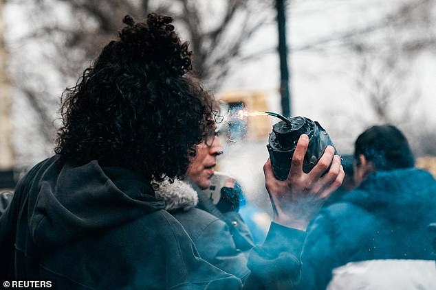 Emir Balat, 18, is pictured allegedly lighting and dropping an explosive at a counter-protest against an anti-Muslim demonstration organized by far-right influencer Jake Lang