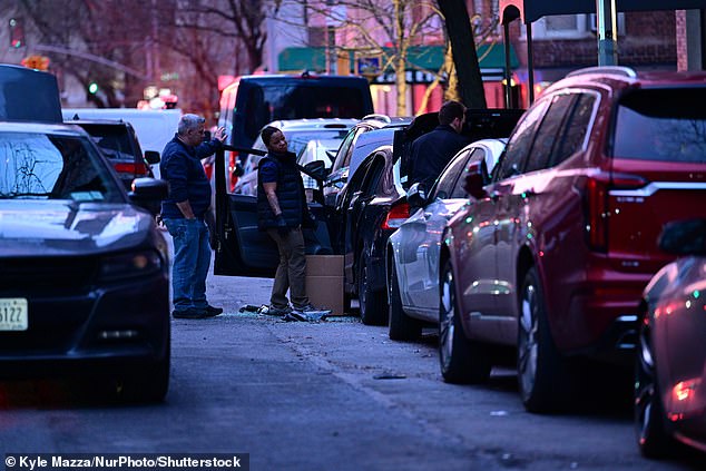 FBI agents collect evidence as a vehicle reportedly tied to terror-related Gracie Mansion protests is towed away after processing and examination in the area of East End Avenue and East 81st Street in Manhattan on Sunday. A third IED was reportedly found in the car