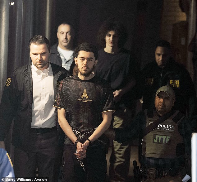 Ibrahim Kayumi (front) and Emir Balat (back) in federal custody leaving the NYPD's 26th Precinct stationhouse in Manhattan on Monday
