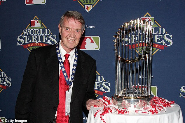 Philadelphia Phillies Hall-of-Fame Broadcaster Harry Kalas is pictured next to the Commissioner's Trophy after the team's 2008 World Series victory