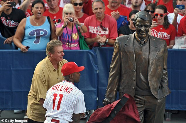 A statue of former Philadelphia Phillies announcer Harry Kalas is unveiled by former pitcher Steve Carlton and Jimmy Rollins #11 of the Philadelphia Phillies before a 2011 game