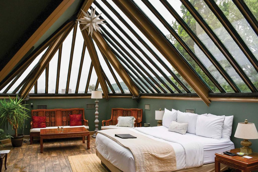 A room with a bed and an arched roof