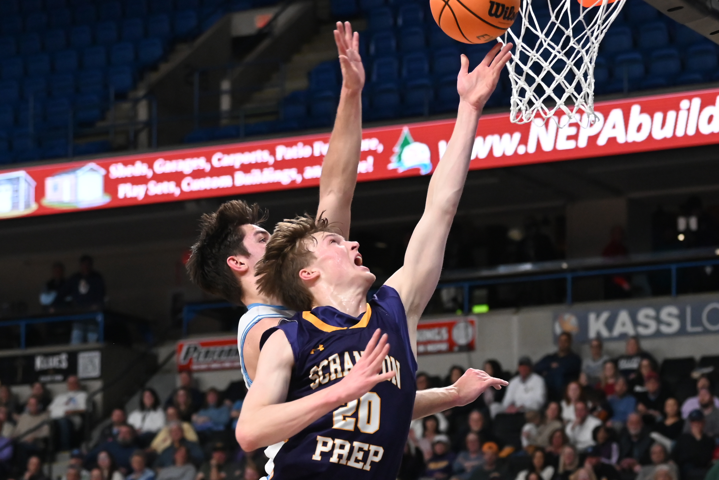 Scranton Prep’s Packy Doherty lifts the ball to the hoop...