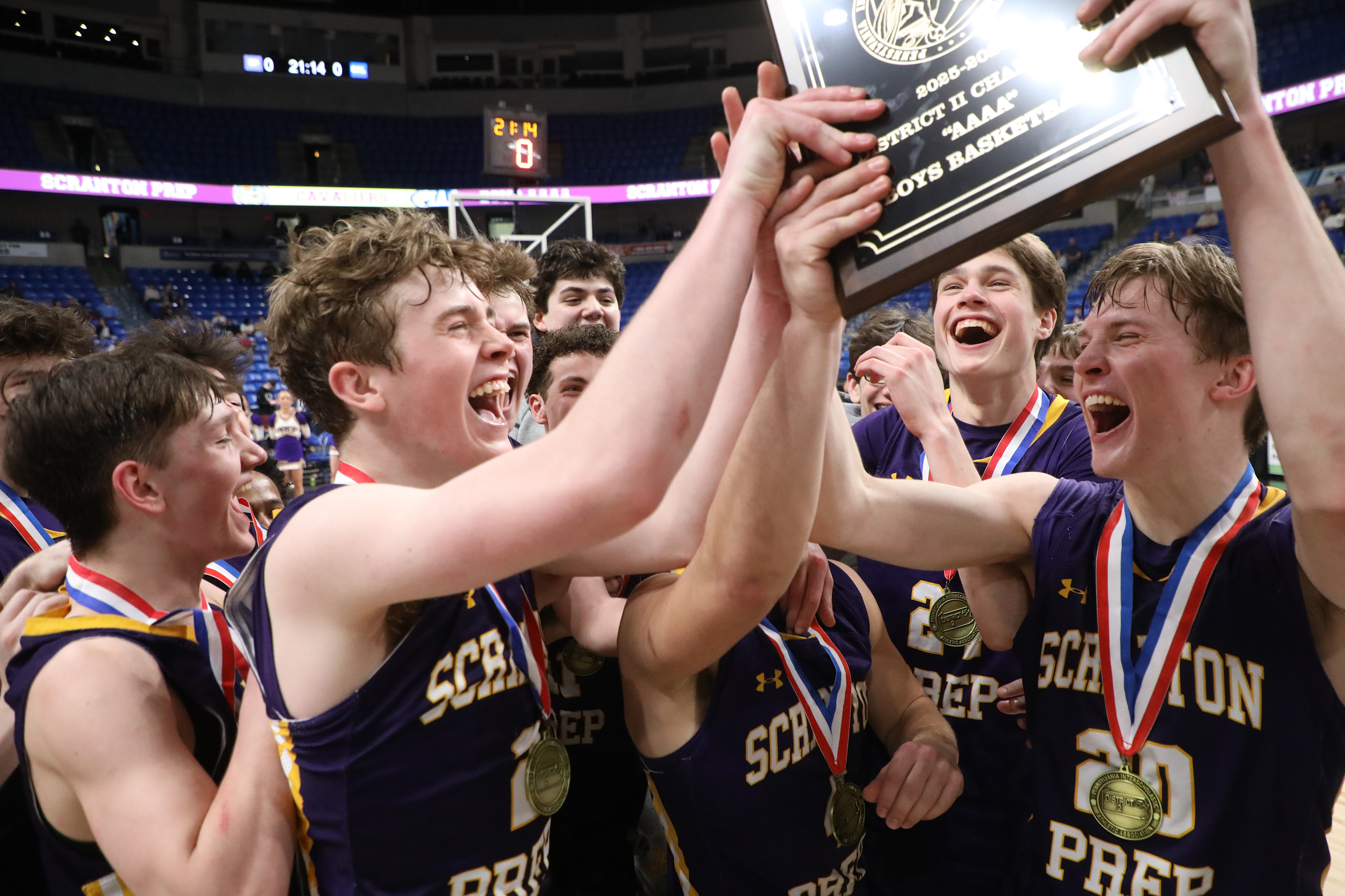 Scranton Prep’s Packy Doherty holds the championship plaque as his...