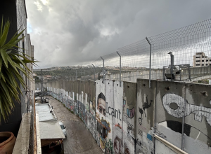 Dark sky over the bleak Separation Wall  surrounding Bethlehem - ICN/JS