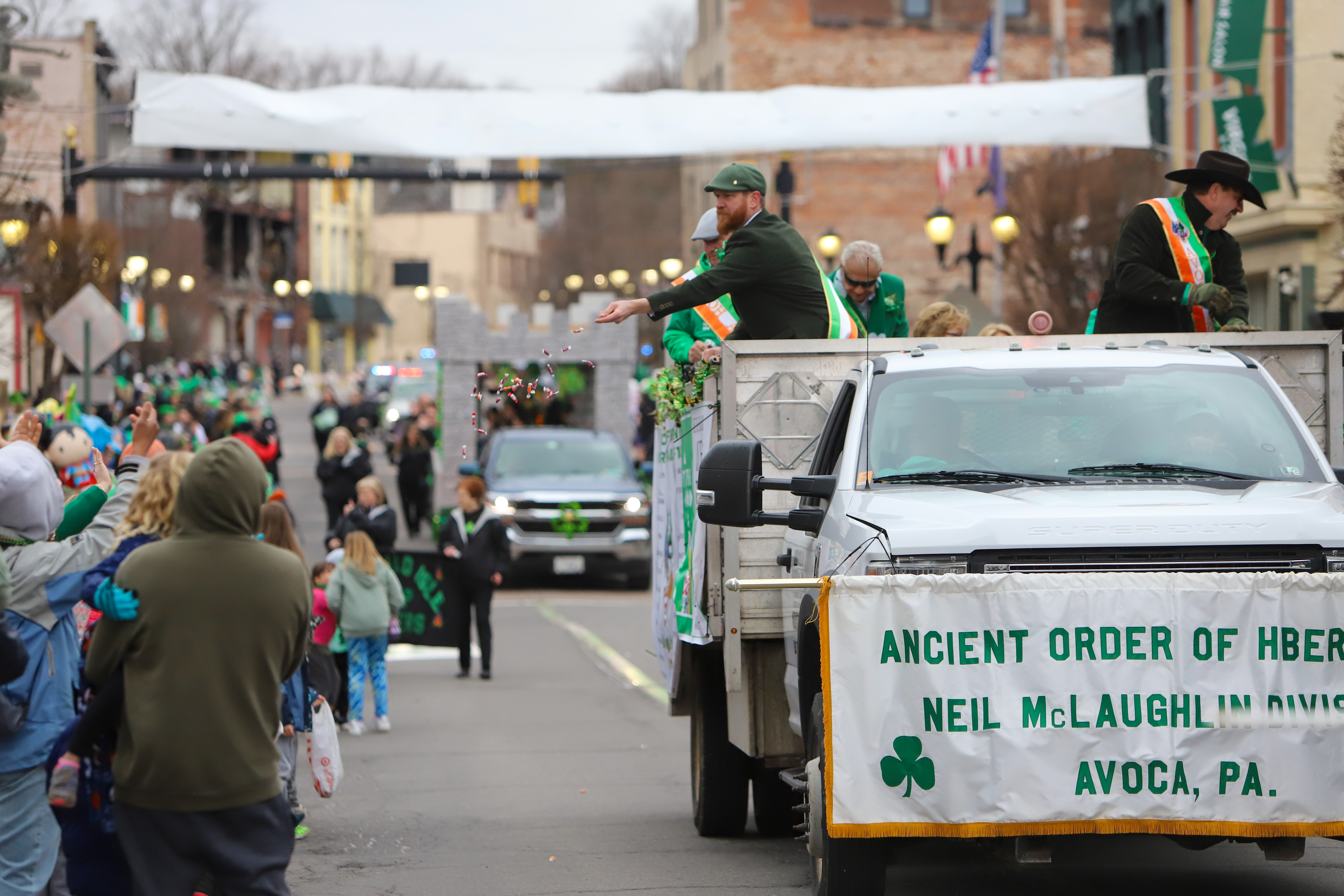 Members of the Avoca Ancient Order of Hibernians throw candy...