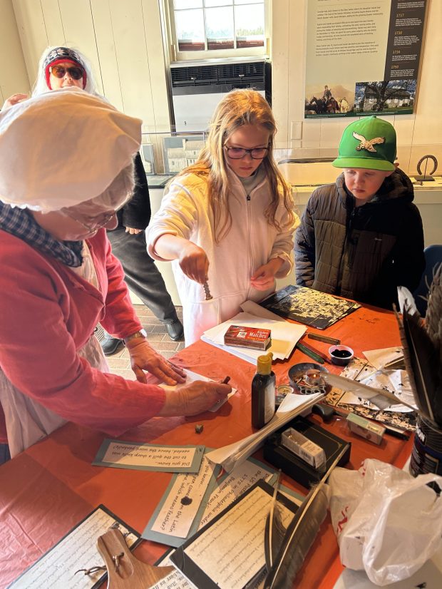 In the Daniel Boone Homestead craft shop, visitors can try writing with a quill pen and learn about education in the 18th century at the open house and living history event on March 8. (Photo courtesy of Daniel Boone Homestead Associates)