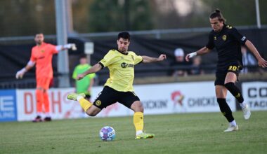 Pittsburgh Riverhounds defender Beto Ydrach clears the ball under pressure from the Charleston Battery