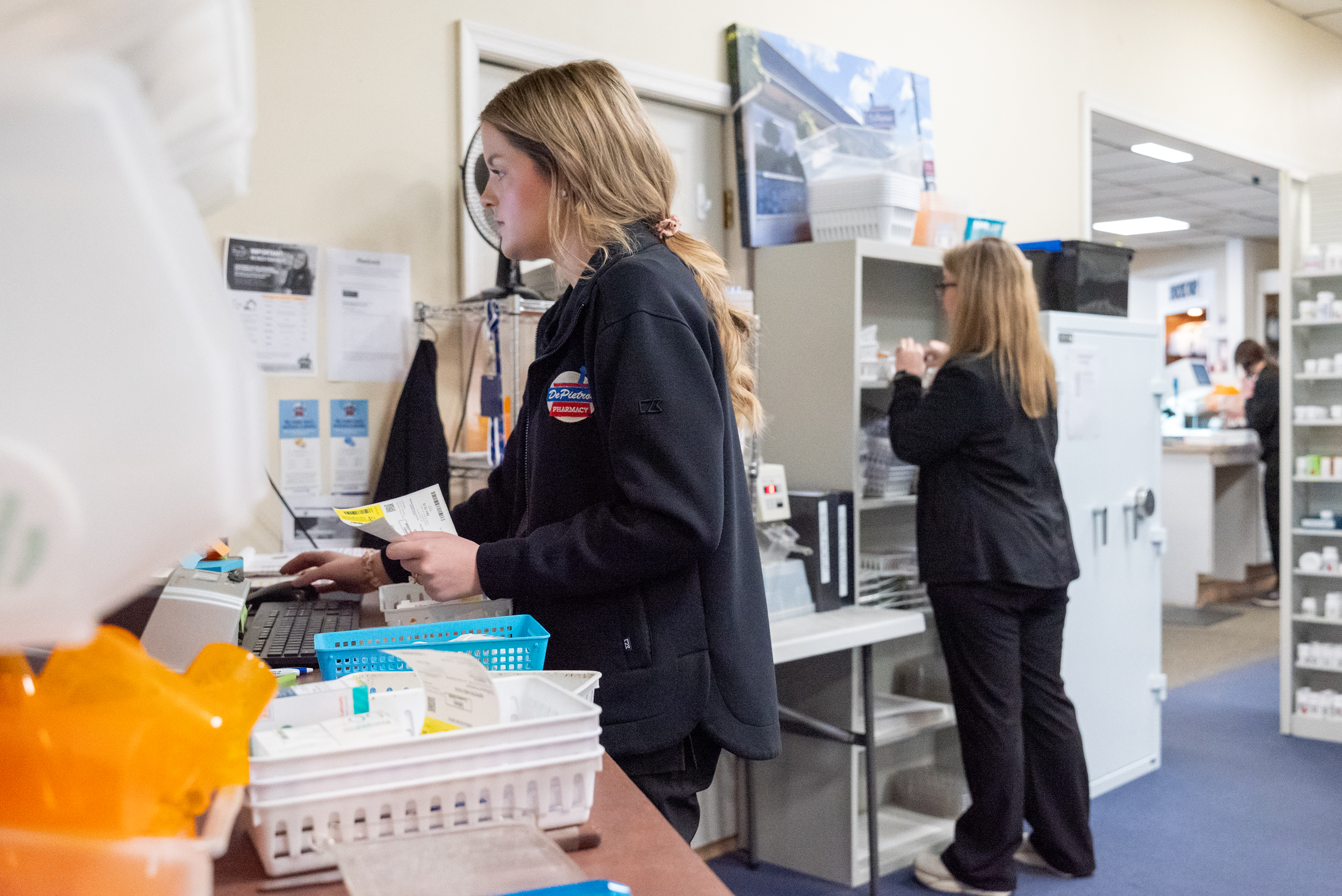 Pharmacy tech Sarah Connor, left, works at fulfilling customer’s deliveries...