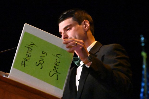State Rep. Rob Bresnahan closes a binder labeled "Friendly Sons Speech" after finishing his remarks during the Friendly Sons of St. Patrick dinner at the Scranton Cultural Center in Scranton on Friday, March 13, 2026. (REBECCA PARTICKA/STAFF PHOTOGRAPHER)