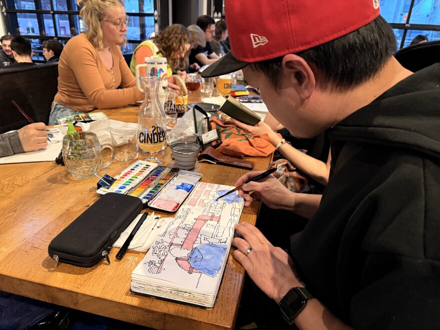 person in baseball hat sketches