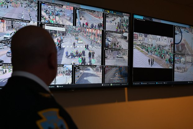 Scranton Police Chief Thomas Carroll watches multiple live street camera feeds from the department's monitoring center, keeping an eye activity across the city during the St. Patrick's Day parade. (GERI GIBBONS/STAFF PHOTO)