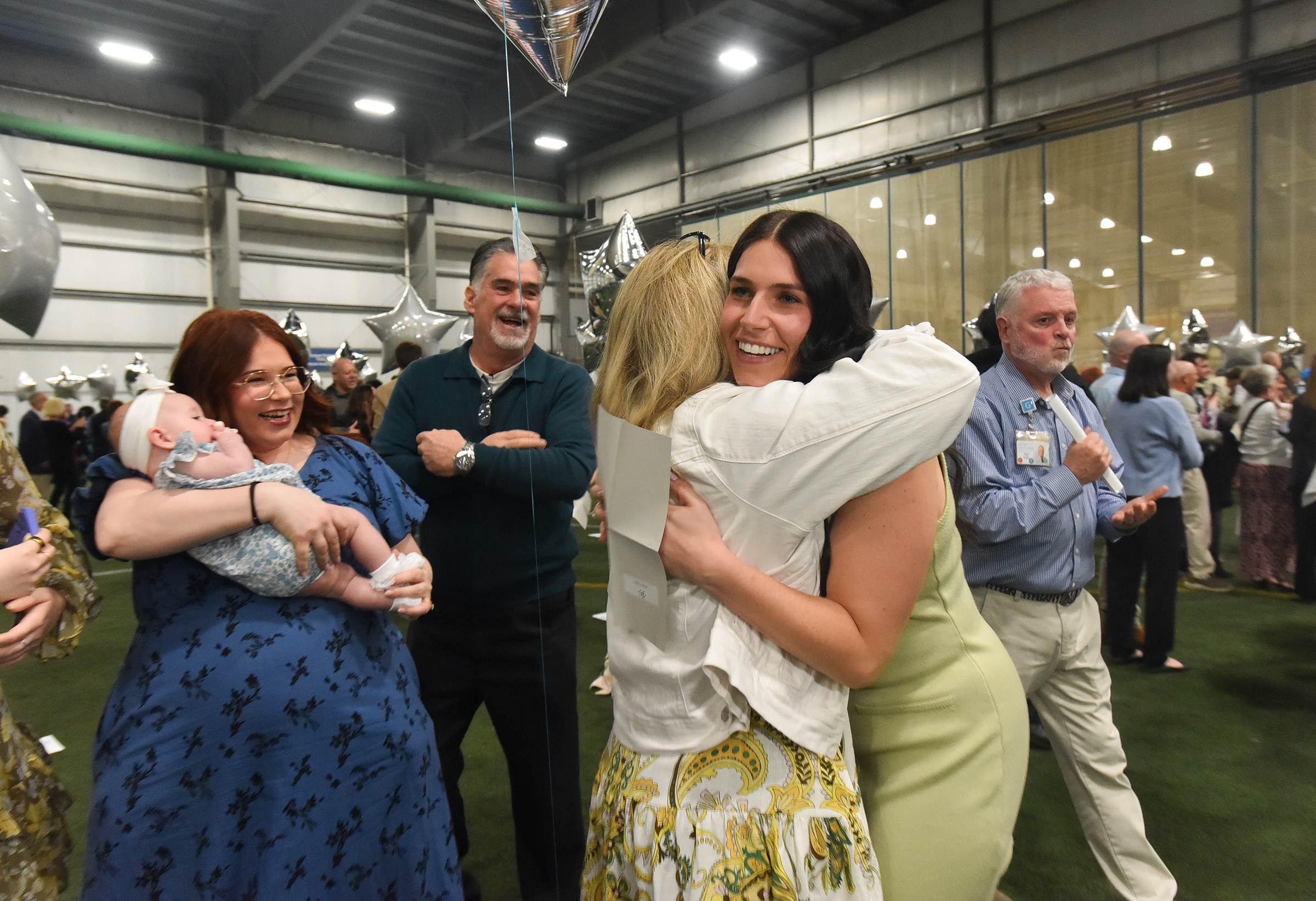 Gina Tallo, of Dunmore, hugs her mother, LIsa, during the...