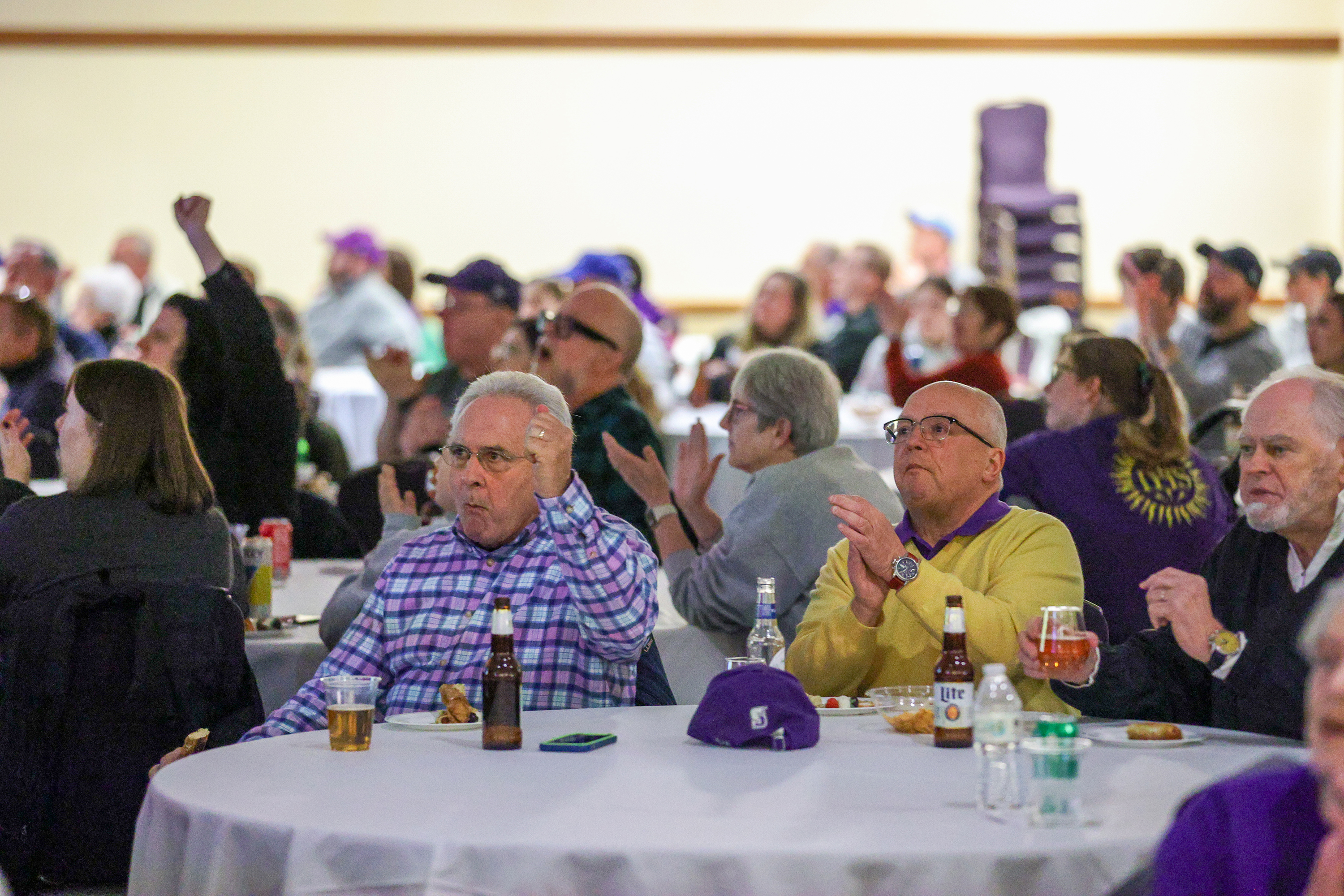 Attendees cheer during a watch party of the NCAA Division...