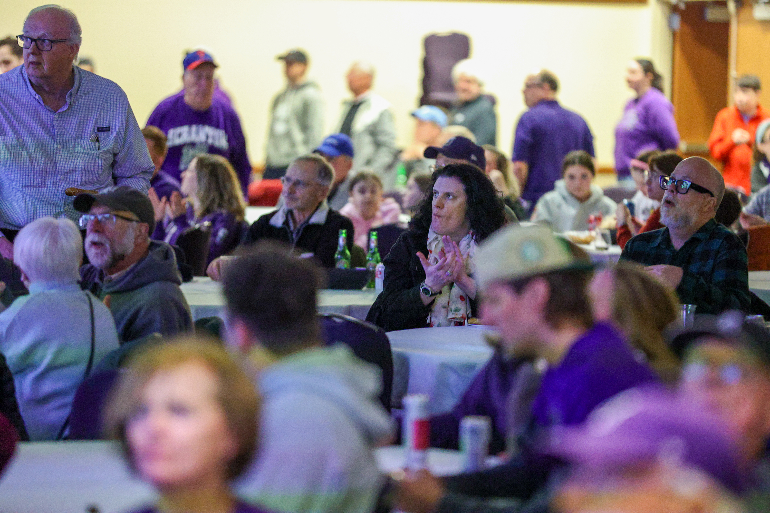 Attendees cheer during a watch party of the NCAA Division...