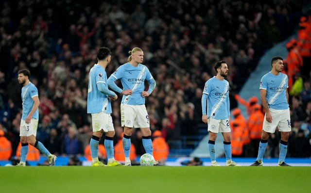 Manchester City players react after Nottingham Forest's goal