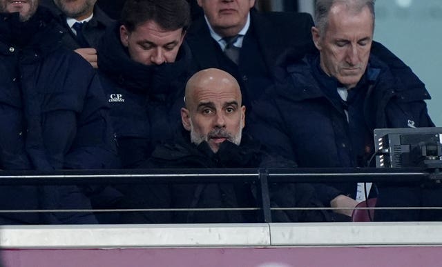 Pep Guardiola watches from the stands