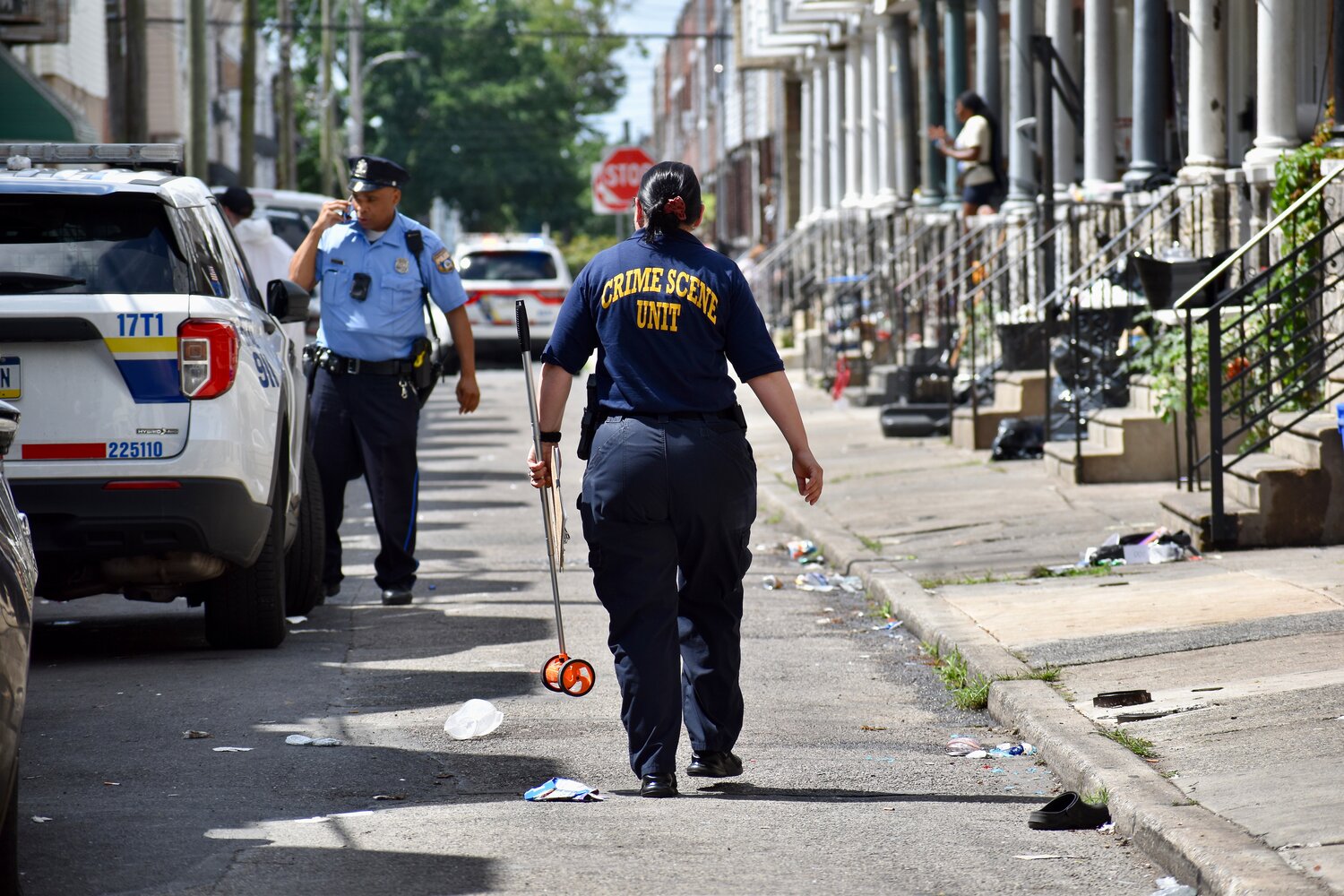 Crime scene investigators are pictured on the scene of a mass shooting Monday, July 7, 2025, on Etting Street in Grays Ferry. Law enforcement officials believe a gun with a switch was used.