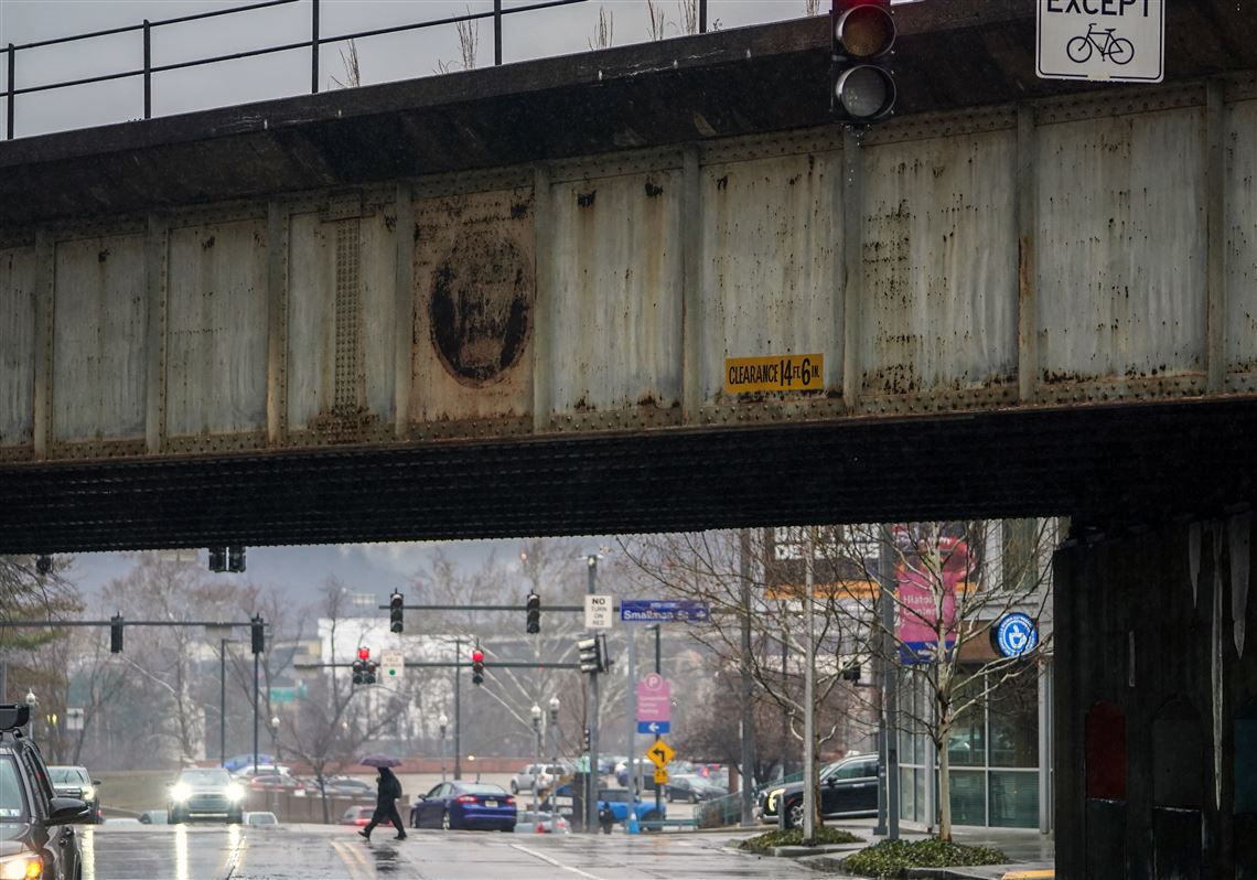 Railroad trestles at Pittsburgh's Strip District entrance will be painted black and gold for NFL Draft