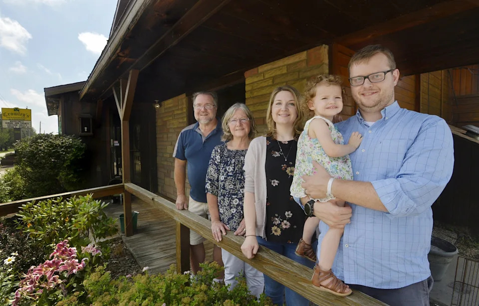 Justin Herring, right, holds his daughter Madeline, as family members gather outside the former Crowley's Restaurant & Lounge in Elk Creek Township. From back left are Herring's in-laws Robert and Patti Tuznik and his wife, Jessica Herring. The group operates Madeline's Dining & Events at the location on Rt. 18.