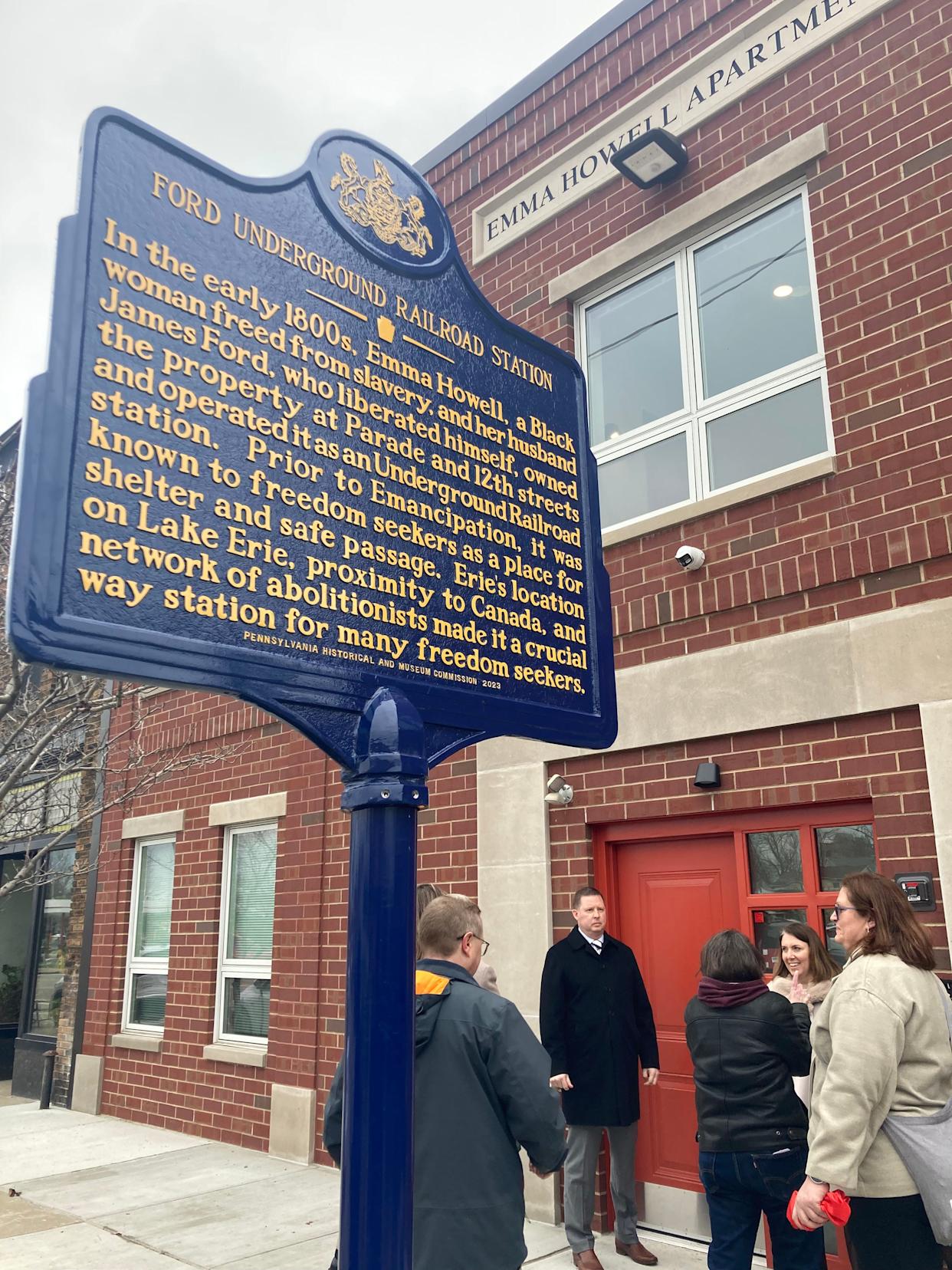 Housing and Neighborhood Development Service CEO Matthew Good, center, and Erie Mayor Daria Devlin, center right, are shown at ceremonies to unveil the new historical marker honoring Emma Howell and family and to dedicate the new Emma Howell Apartments on March 27.