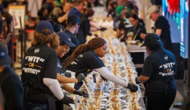 Assemblers prepare the cheesesteaks at Philadelphia International Airport Tuesday to attempt to set a Guinness World Record for the longest line of cheesesteaks.