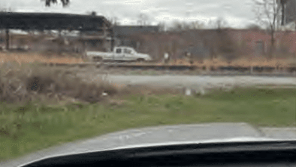 A photo submitted by DEP inspector Kalen Boyer in his inspection report. He captioned the photo, "Tan pick up truck that entered the Site with the scrap metal desk leaving the Site empty."