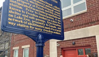 Housing and Neighborhood Development Service CEO Matthew Good, center, and Erie Mayor Daria Devlin, center right, are shown at ceremonies to unveil the new historical marker honoring Emma Howell and family and to dedicate the new Emma Howell Apartments on March 27.