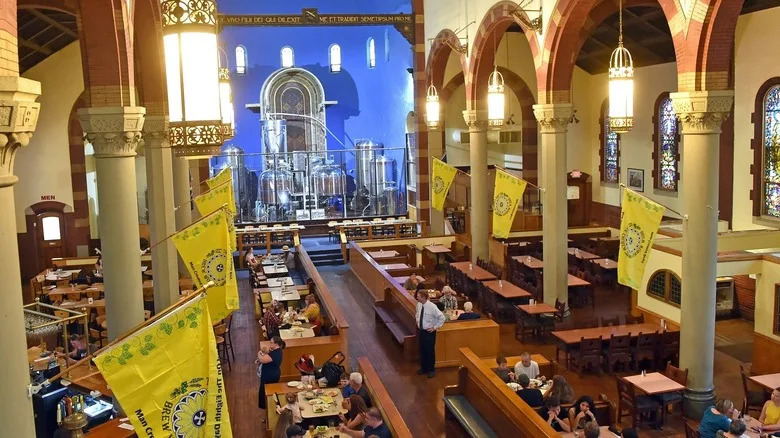 high angle of a church with dining tables and large tanks at the altar