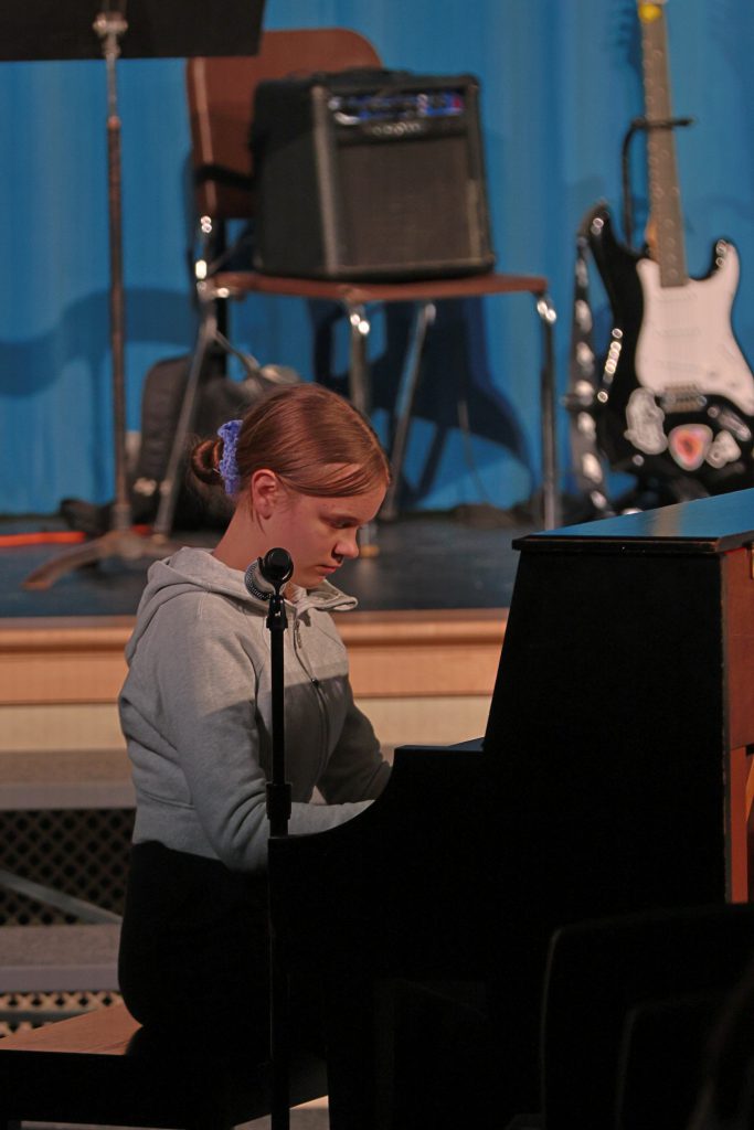 student plays piano
