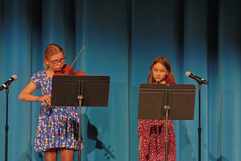 two students playing violins