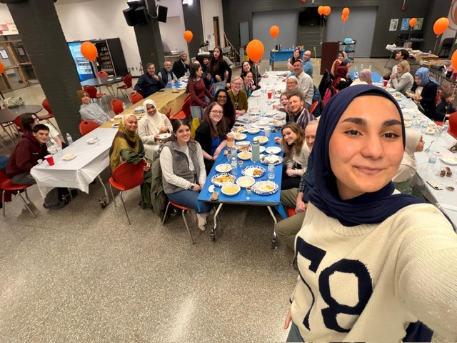 student takes selfie of group