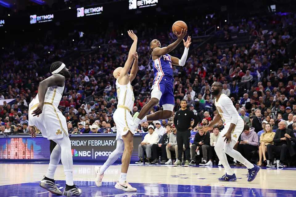 Nov 11, 2025; Philadelphia, Pennsylvania, USA; Philadelphia 76ers guard Tyrese Maxey (0) drives for a shot against Boston Celtics guard Jordan Walsh (27) and guard Jaylen Brown (7) during the fourth quarter at Xfinity Mobile Arena. Mandatory Credit: Bill Streicher-Imagn Images