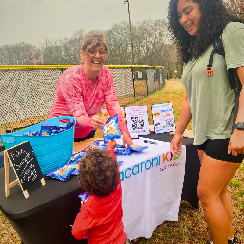 Little boy reaching for Bamba snack at Stephanie Cook event