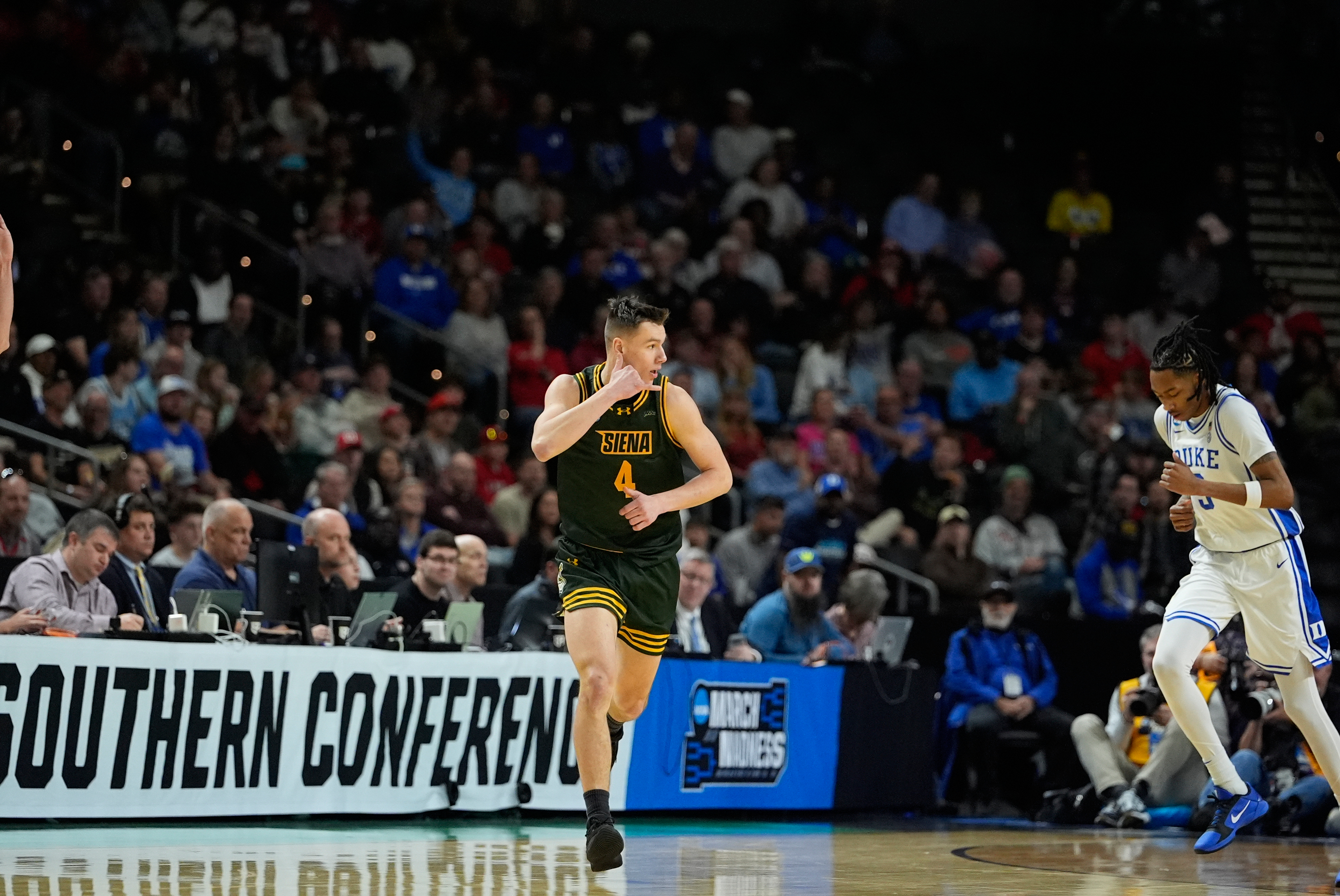 Siena guard Gavin Doty (4) celebrates after scoring during the...