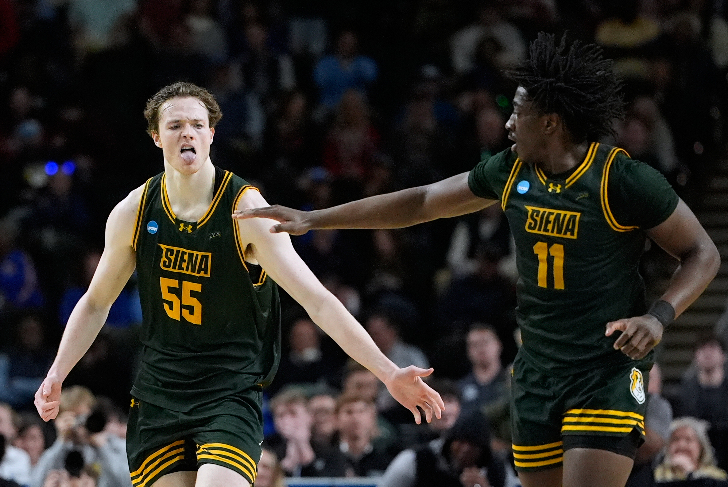 Siena center Riley Mulvey (55) reacts after scoring during the...