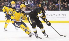 Sarnia Sting's Ben Pickell (12) drives to the net with Erie Otters' Julius Saari (6) at Progressive Auto Sales Arena in Sarnia, Ont., on Wednesday, March 18, 2026. Mark Malone/Chatham Daily News/Postmedia Network