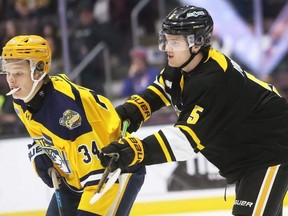 Sarnia Sting's Mitch Young (5) checks Erie Otters' Kase Kamzik (34) at Progressive Auto Sales Arena in Sarnia, Ont., on Wednesday, March 18, 2026. Mark Malone/Chatham Daily News/Postmedia Network