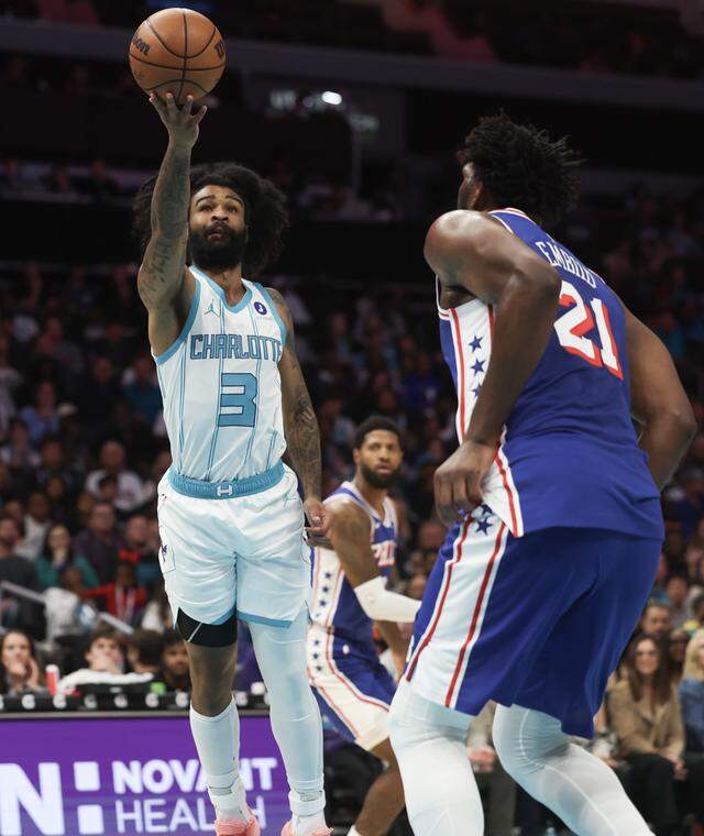 Charlotte Hornets guard Coby White puts up the shot against Philadelpha 76ers center Joel Embiid Saturday, March 28, 2026 at Spectrum Center in Charlotte.