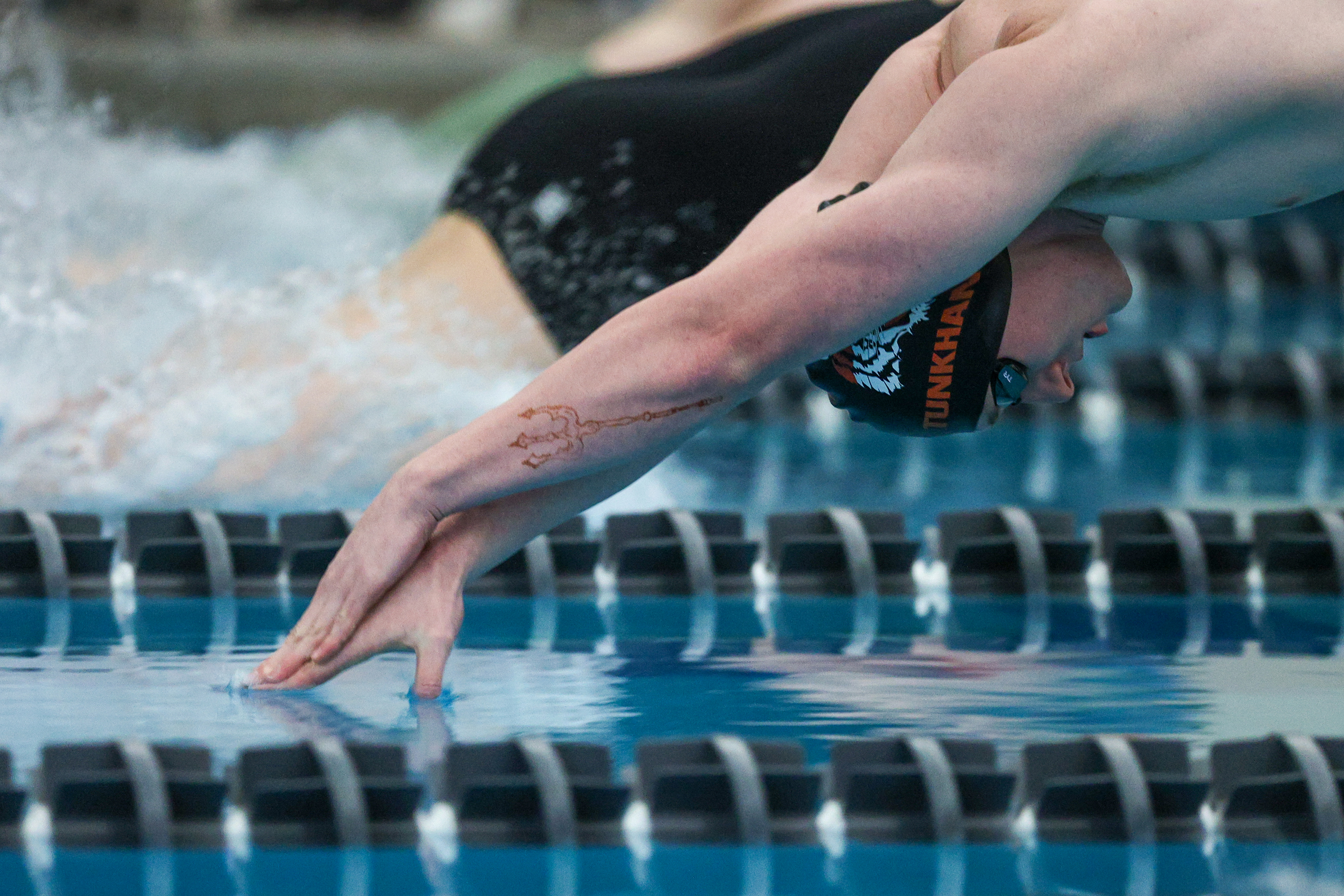 Tunkhannock Area’s Jaden Baltrusaitis enters the water for the 100...