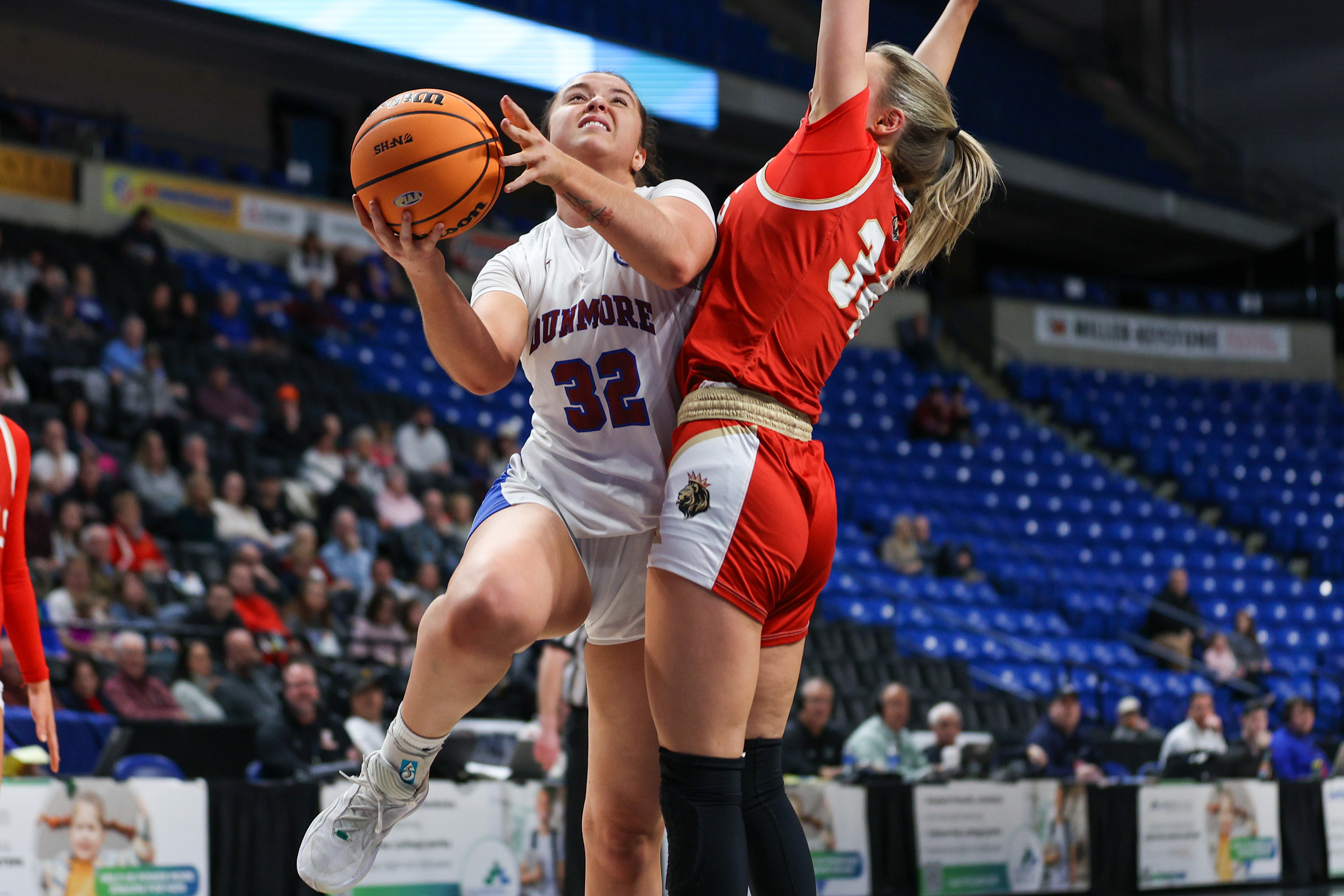 Dunmore’s Michelle Nidoh (32) takes a shot as Holy Redeemer’s...