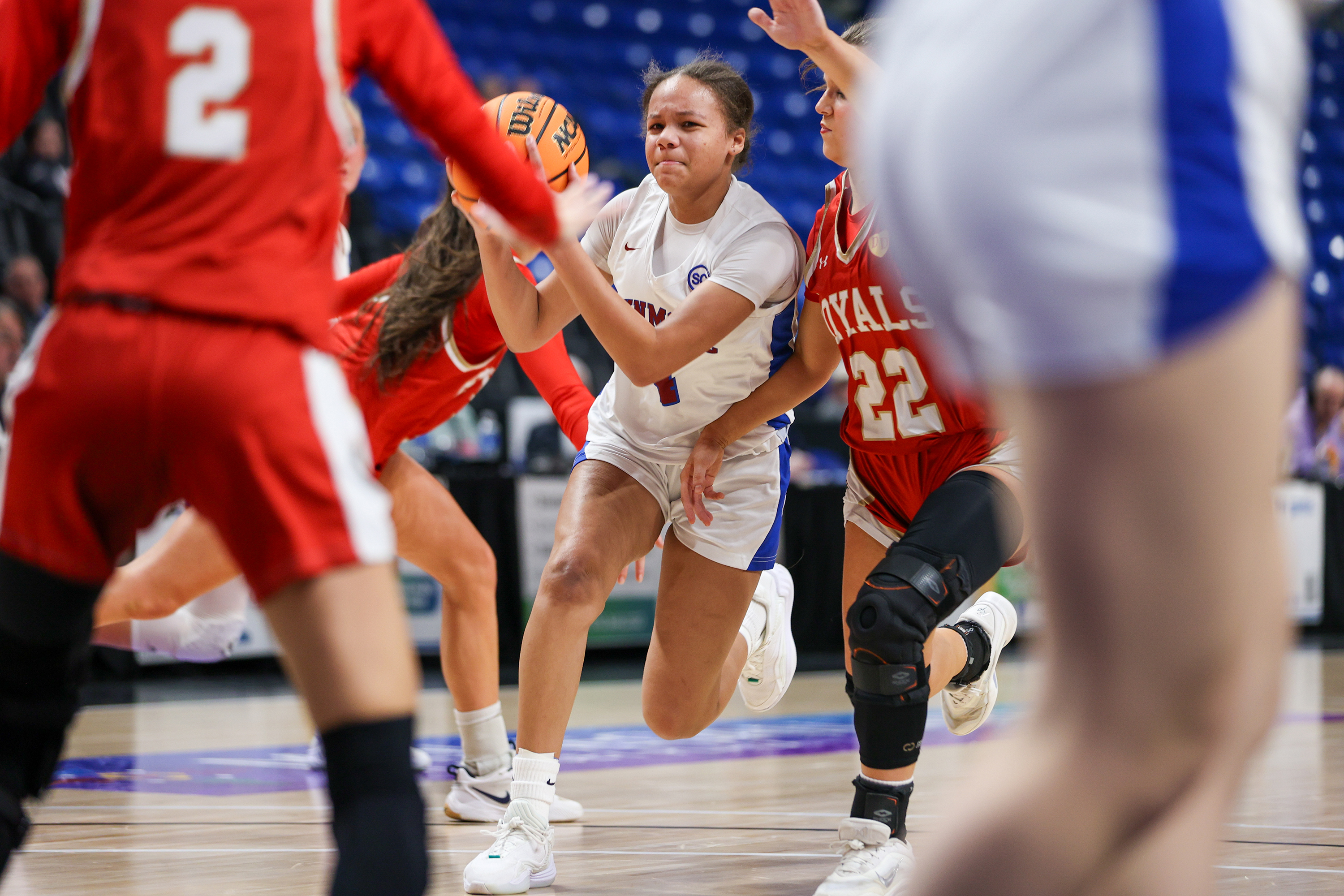 Dunmore’s Janessa Martin (4) drives through the Holy Redeemer defense...