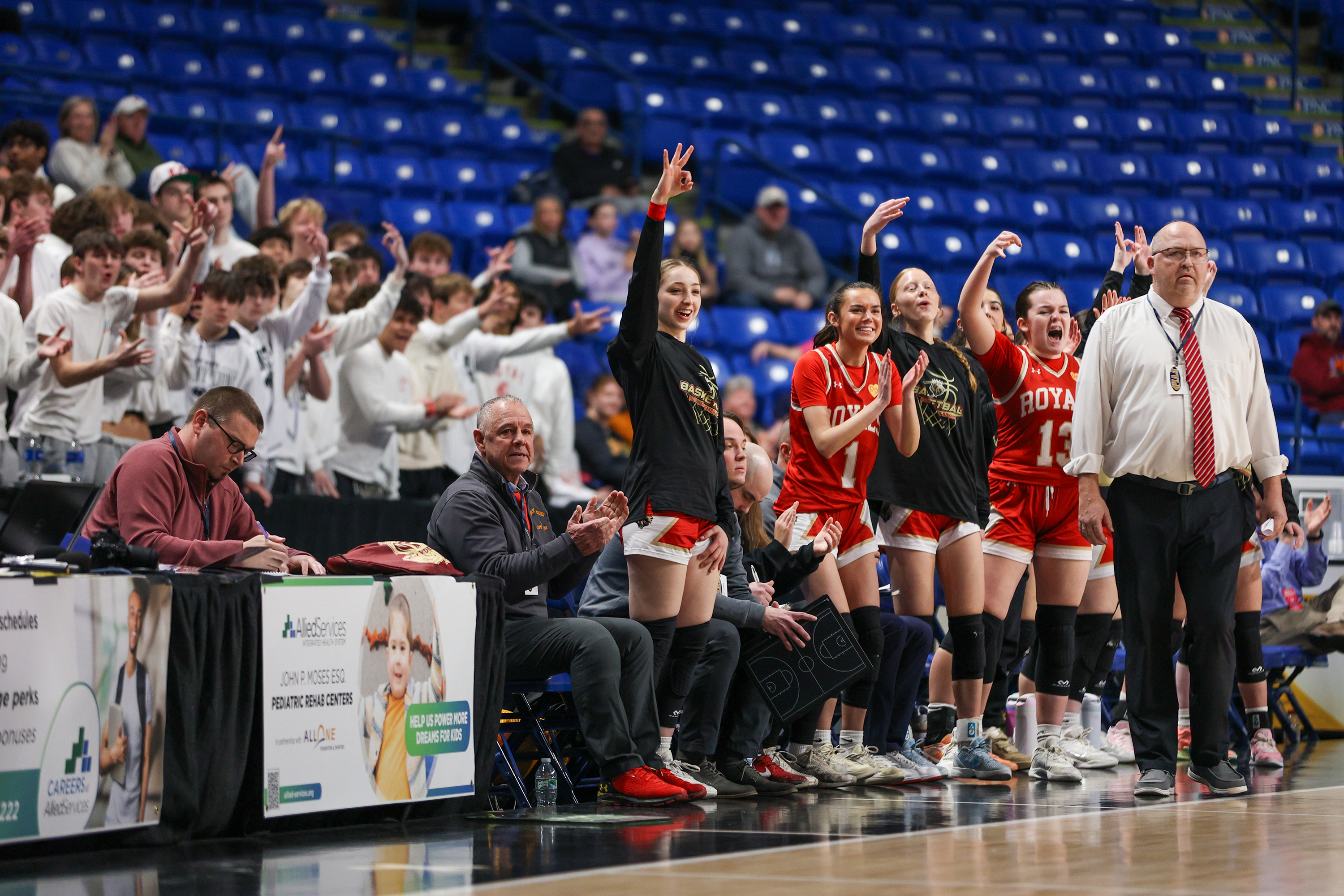 Holy Redeemer’s bench reacts after scoring during the District 2...