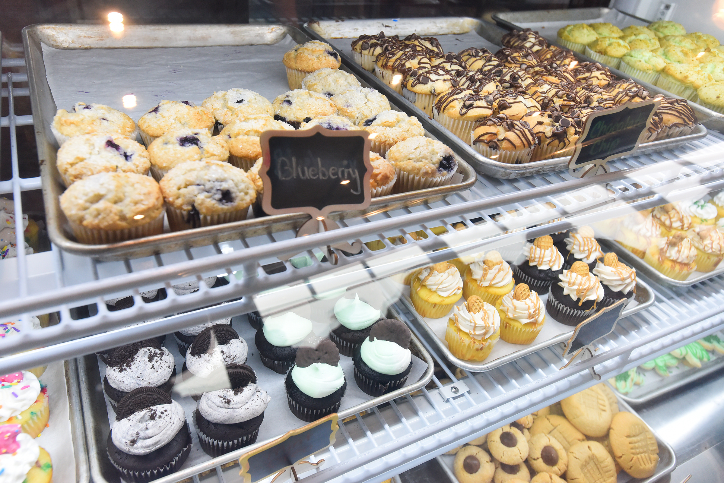 Baked goods are presented in a case at Coffee Inclusive...