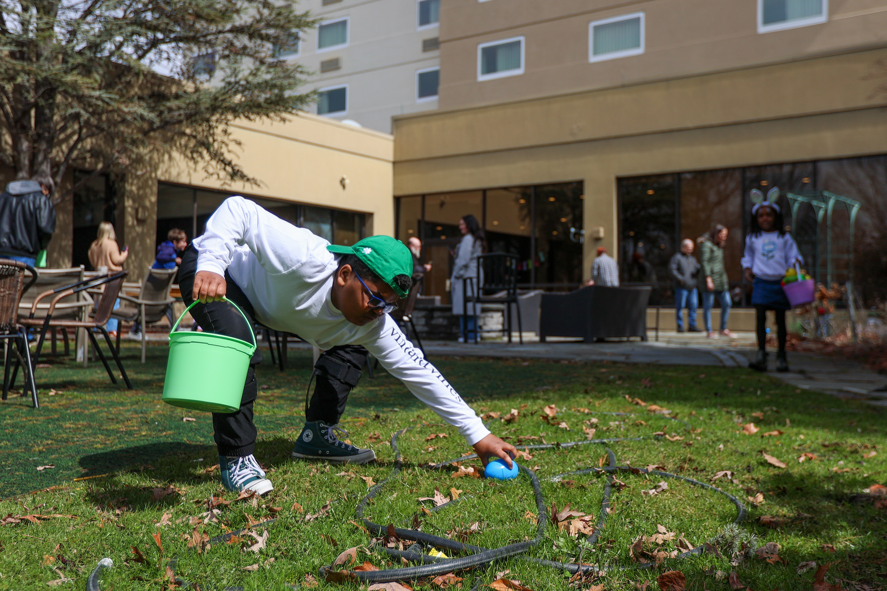 Kase Bickauskas, 11, of Jefferson Twp., picks up an egg...