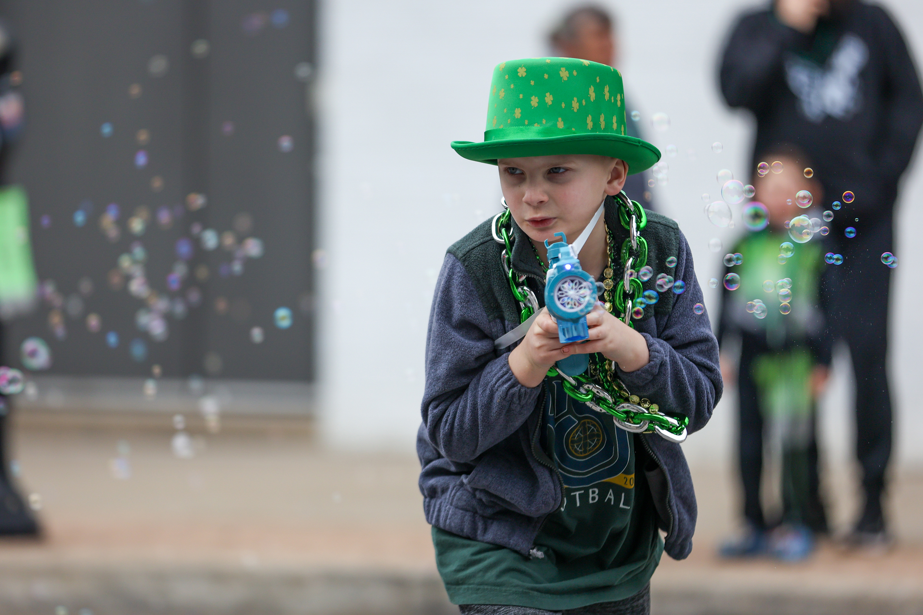 Cameron Warner, 8, of Exeter, plays with a bubble gun...