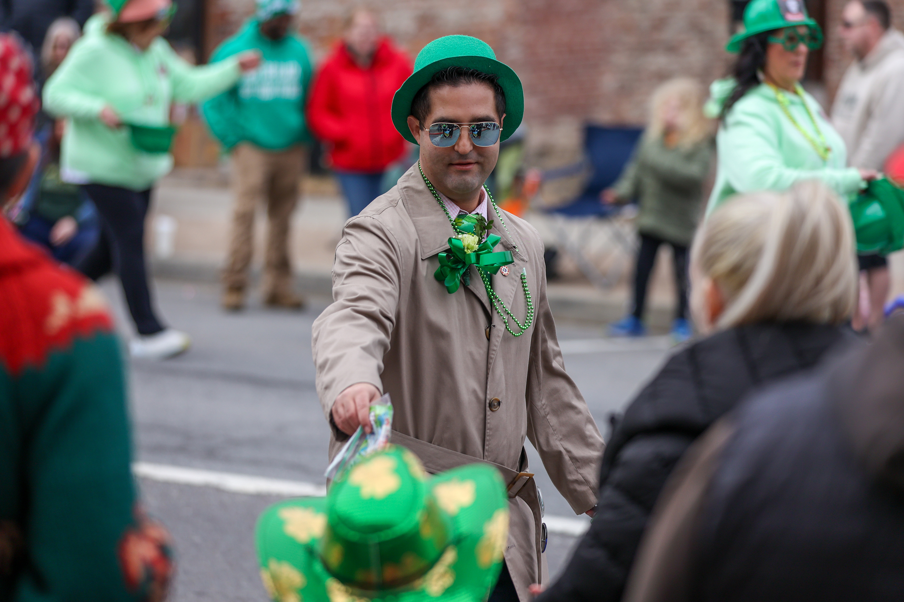 Luzerne County Council member John Lombardo gives out bags of...