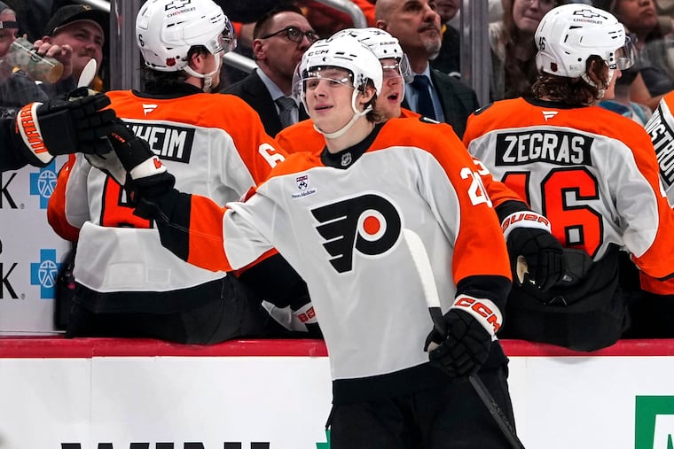 Alex Bump, center, returns to the bench after scoring his debut goal during the second period of Saturday's game against Pittsburgh.