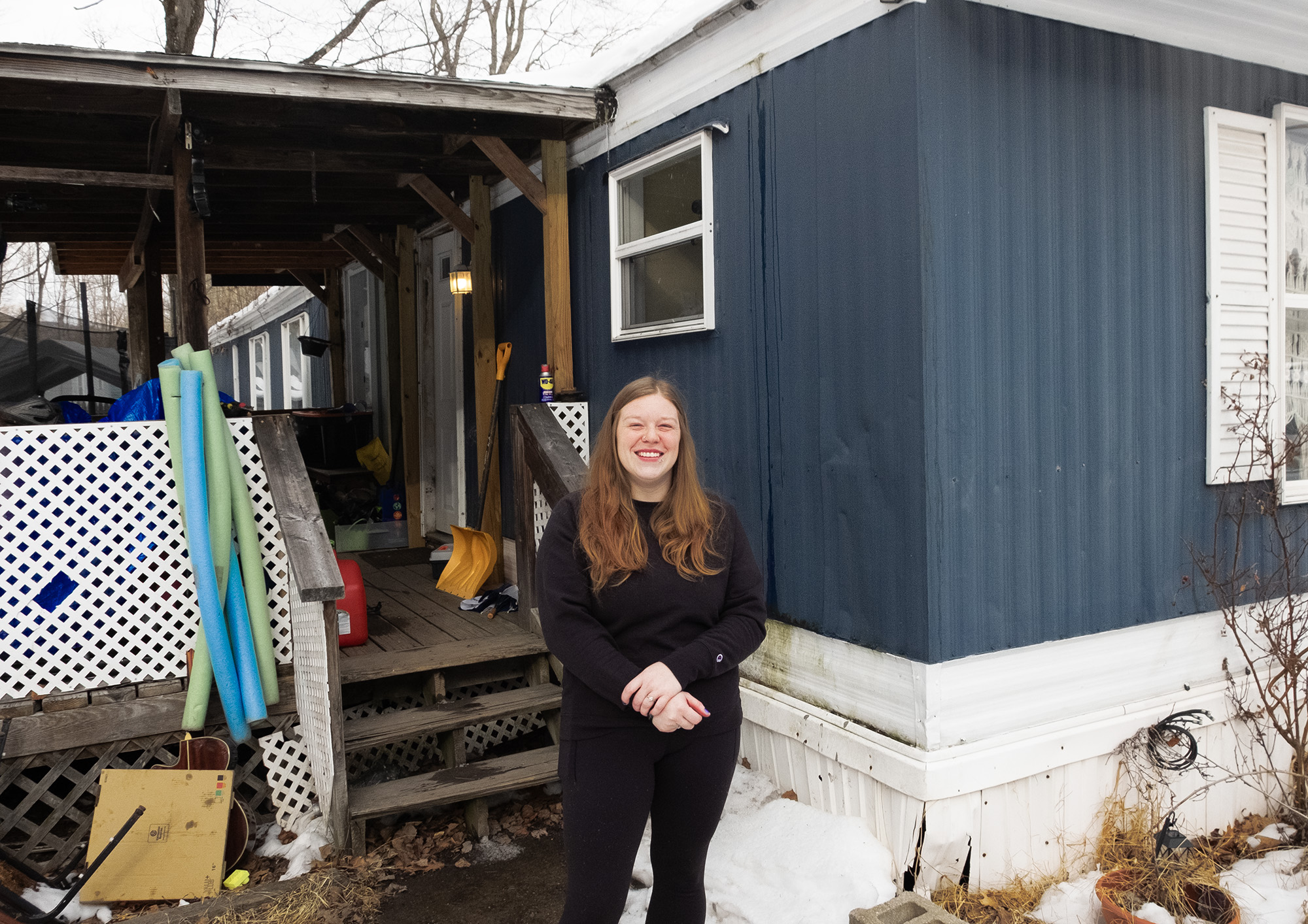 Candace May stands in the snow outside her mobile home.
