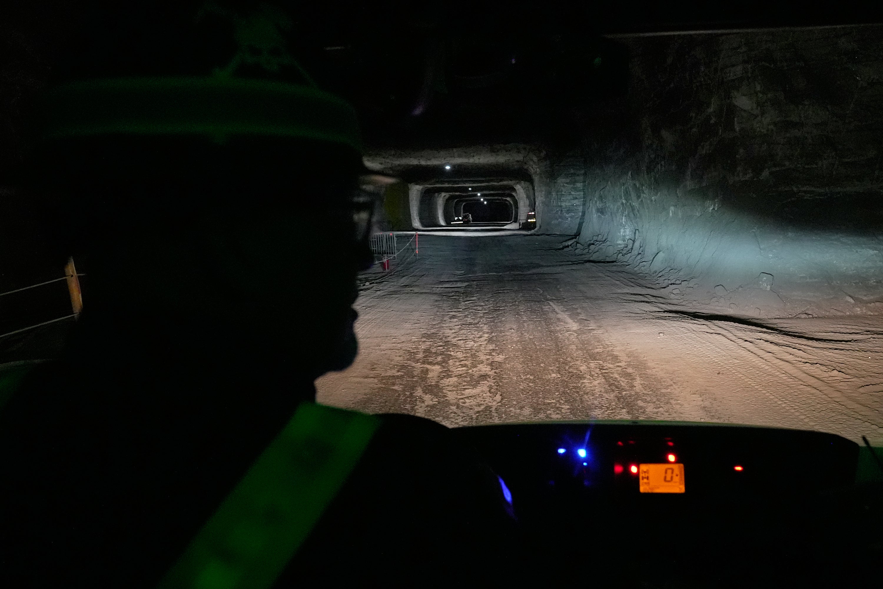 The headlights of the vehicle driven by George Campbell, left, maintenance supervisor, light the way through the tunnels of the Cargill Cleveland salt mine in Whiskey Island